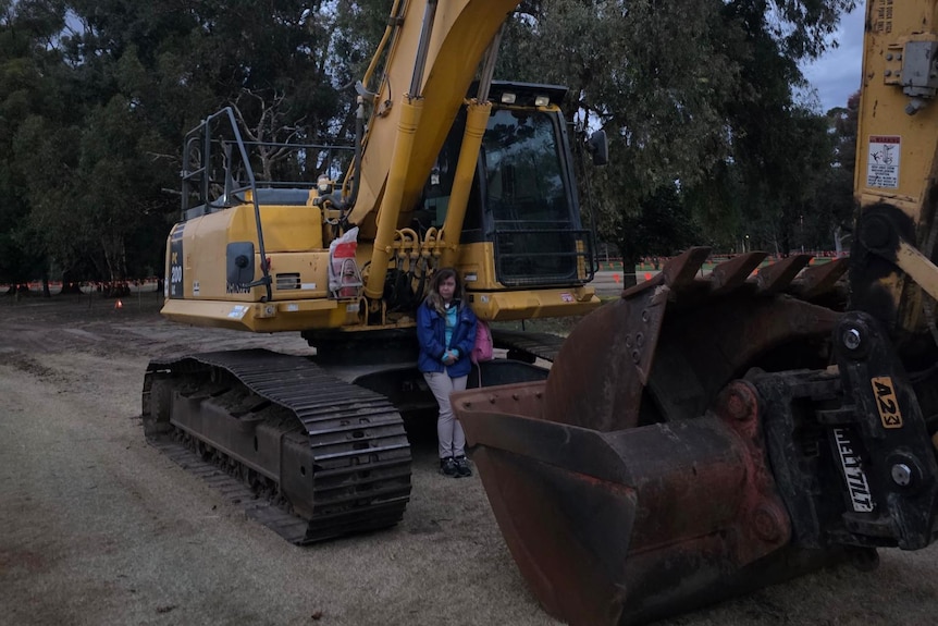 A protester sits by a tractor at the site of the golf course redevelopment.