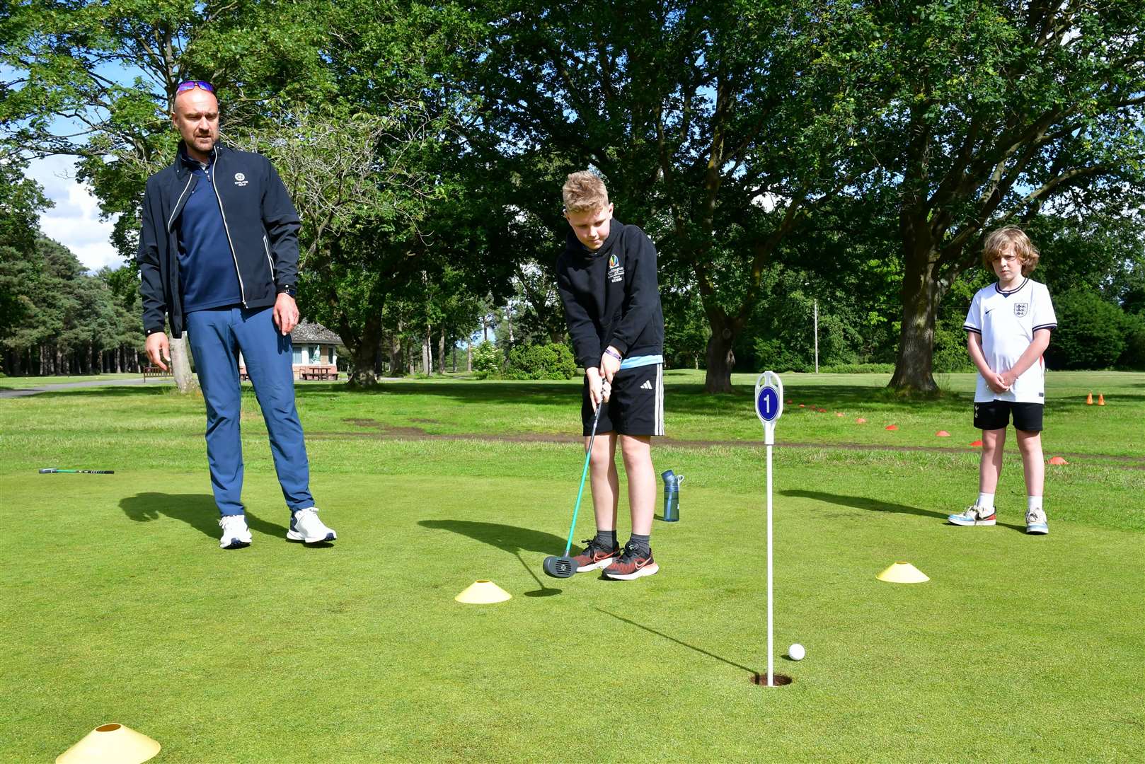 Children on the putting green with community golf instructor, Doug. Photo: Iliffe Media/David Dawson