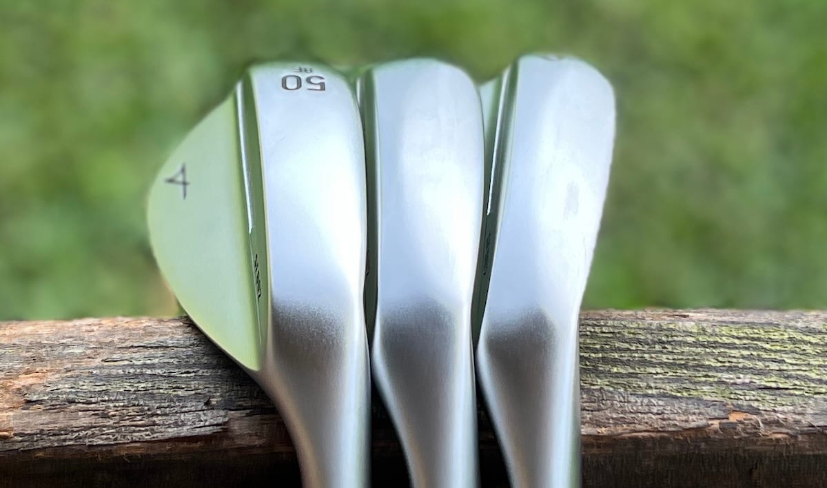Takomo Skyforger 002 wedges — 50, 56 and 60 degree heads lined up on a fence rail