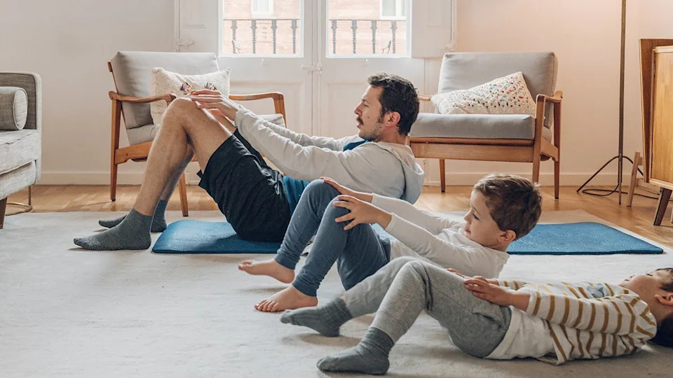 Father with children exercising at home