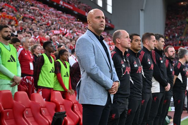 Liverpool's Dutch manager Arne Slot and his assistants observe a moment of silence to pay tribute to Liverpool's late Portuguese forward Diogo Jota and his brother Andre Silva, who passed away in a car crash ahead of the English Premier League football match between Liverpool and Bournemouth at Anfield in Liverpool, north west England on August 15, 2025. (Photo by Paul ELLIS / AFP) / RESTRICTED TO EDITORIAL USE. No use with unauthorized audio, video, data, fixture lists, club/league logos or 'live' services. Online in-match use limited to 120 images. An additional 40 images may be used in extra time. No video emulation. Social media in-match use limited to 120 images. An additional 40 images may be used in extra time. No use in betting publications, games or single club/league/player publications. /  (Photo by PAUL ELLIS/AFP via Getty Images)