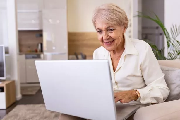 Pensioner using laptop for internet banking