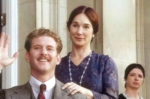 A man, a woman and a maid smile 