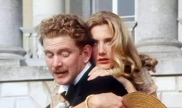 A woman embraces a man