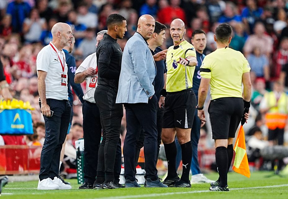 Referee Anthony Taylor speaks with Liverpool manager Arne Slot (left) and Bournemouth manager Andoni Iraola after Bournemouth's Antoine Semenyo (not pictured) informs the referee of a possible racial comment from the crowd during the Premier League match at Anfield, Liverpool