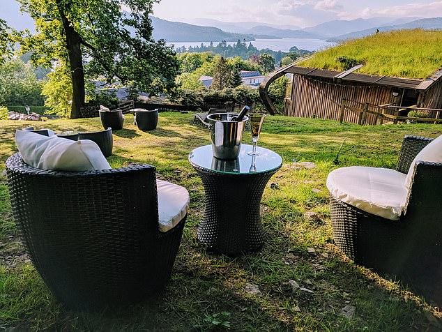 Outdoor seating with a bottle of wine looking out over the stunning views of Windemere