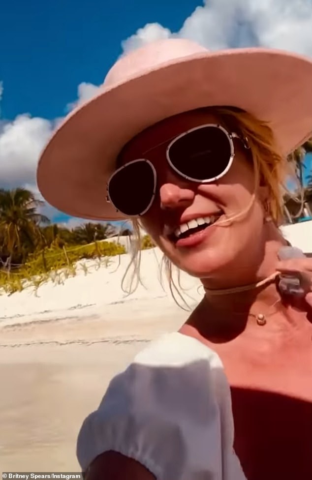 Britney was wearing a pink Joanne-style boater hat and she drew attention to her floral choker, which is a piece from her upcoming jewelry brand, B. Tiny