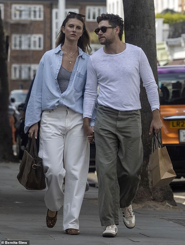 Niall Horan looked loved-up as he walked hand-in-hand with girlfriend Amelia Woolley during a shopping trip in Notting Hill, London on Wednesday