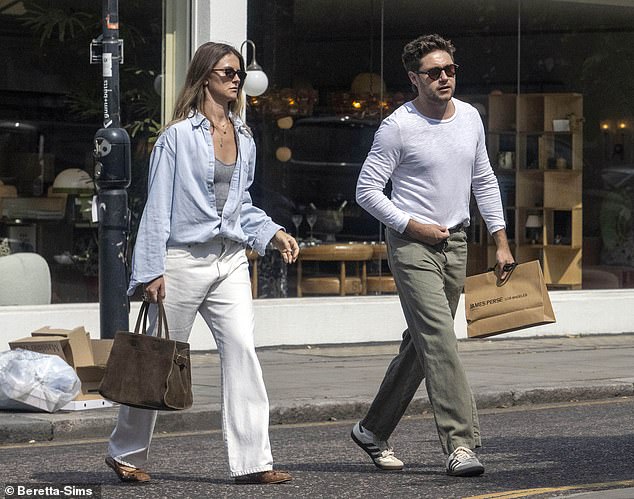 The couple chatted away as they crossed the road