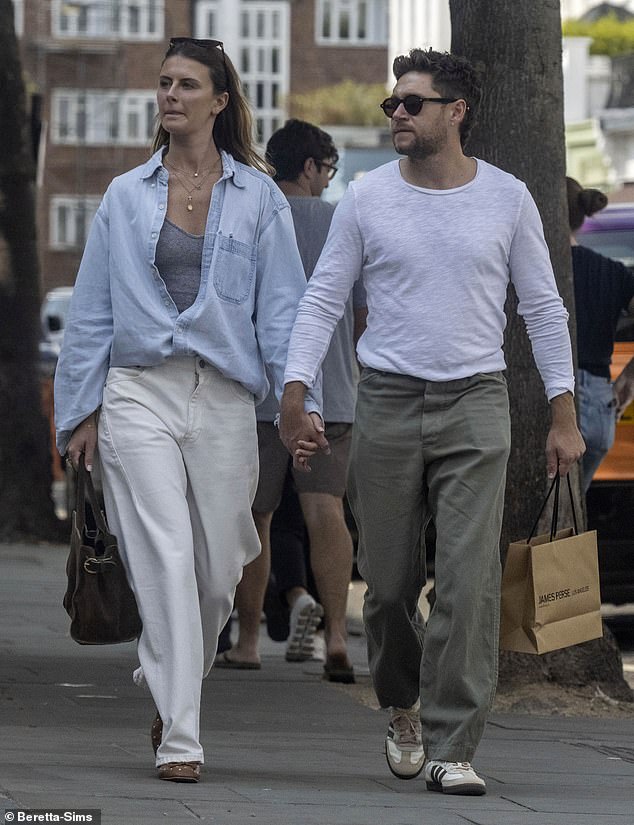 He kept comfortable in a pair of beige and brown trainers and opted for a pair of sunglasses
