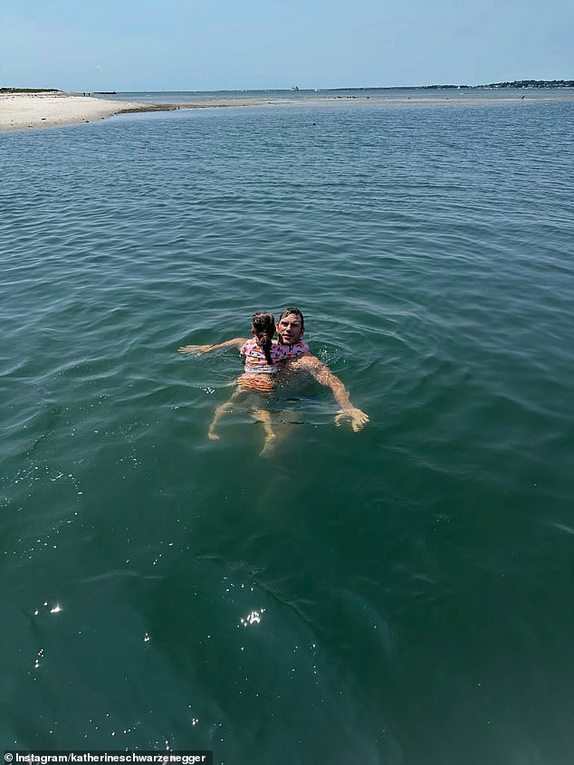 While they relaxed on the boat, Pratt cooled down in the water with his daughter Lyla