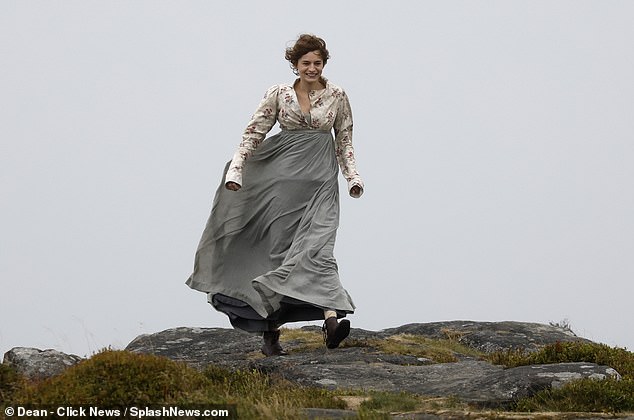 Crown star Emma was just as windswept in a billowing grey silk dress worn with an empire line long-sleeved floral jacket and lace-up ankle boots