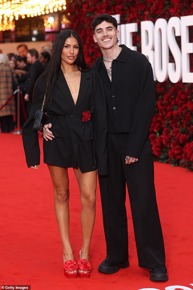 Emily Faye Miller put on a very leggy display in a black blazer dress as she posed alongside her partner Cam Holmes