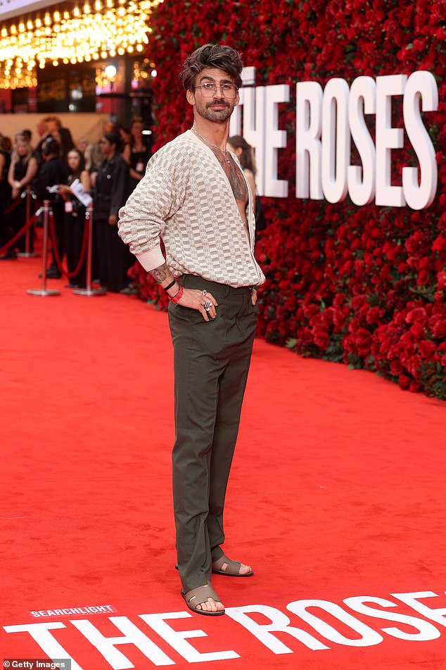 Love Island star Chris Taylor flashed his bare chest beneath a checked shirt which he paired with sandals