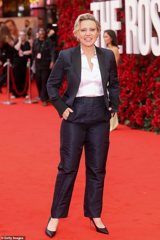 Kate McKinnon opted for a black business suit and white shirt