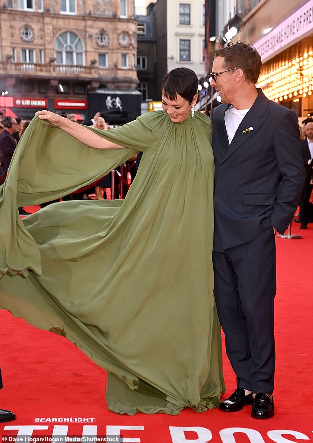 The actress appeared to be struggling with the amount of material as she rearranged the dress