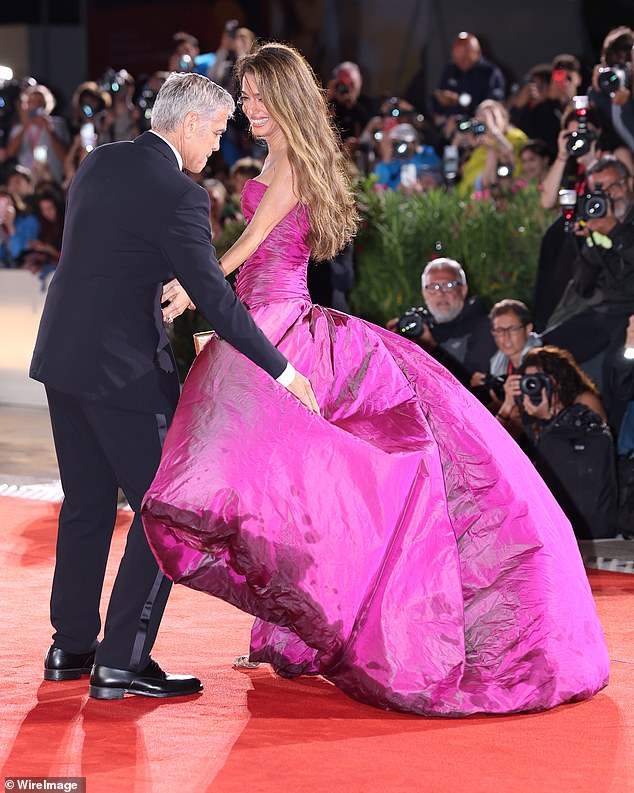 George attempted to keep the skirt down as it blew in the wind