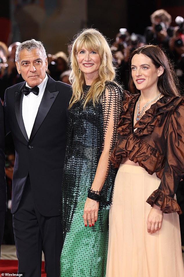 Riley opted for a brown plunging blouse and light peach coloured skirt