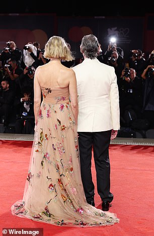 The dress cascaded on the floor in a beautiful train