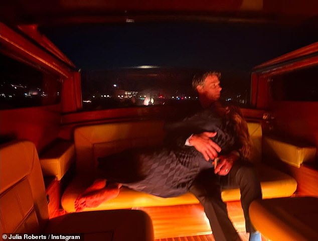Julia Roberts, 57, shared a photo of herself cuddled up to husband Danny Moder, 56, in the back of their water taxi in on social media late Friday.  'Venice' she wrote next to the romantic shot