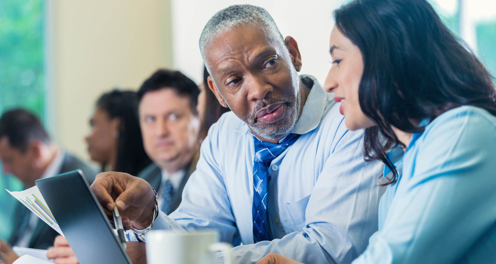 businessman talks with businesswoman at a professional seminar