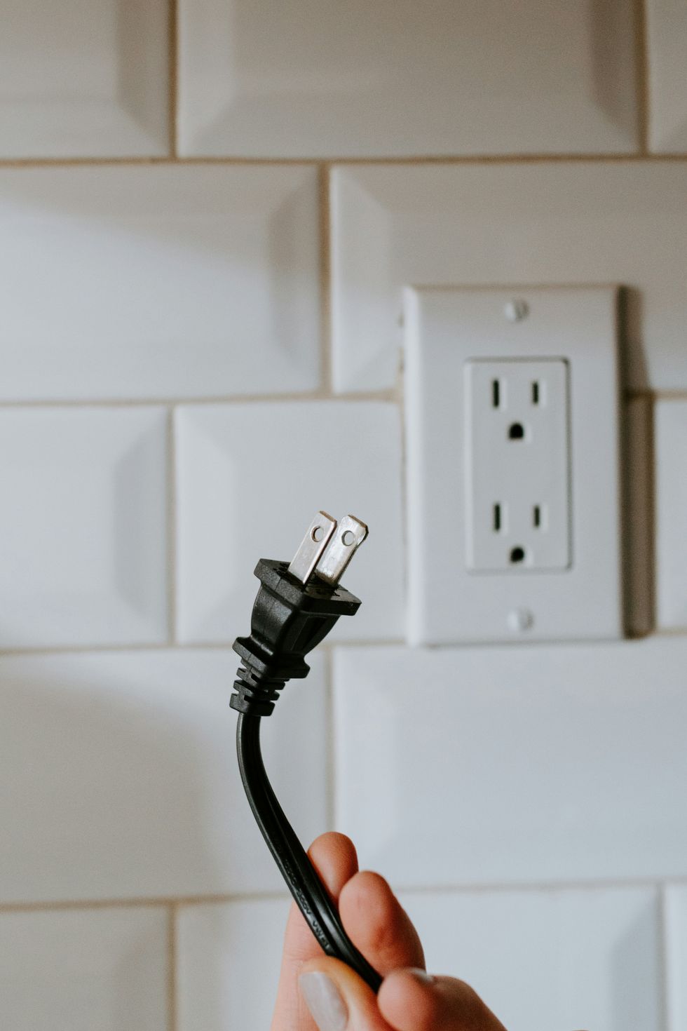 hands holding a plug
