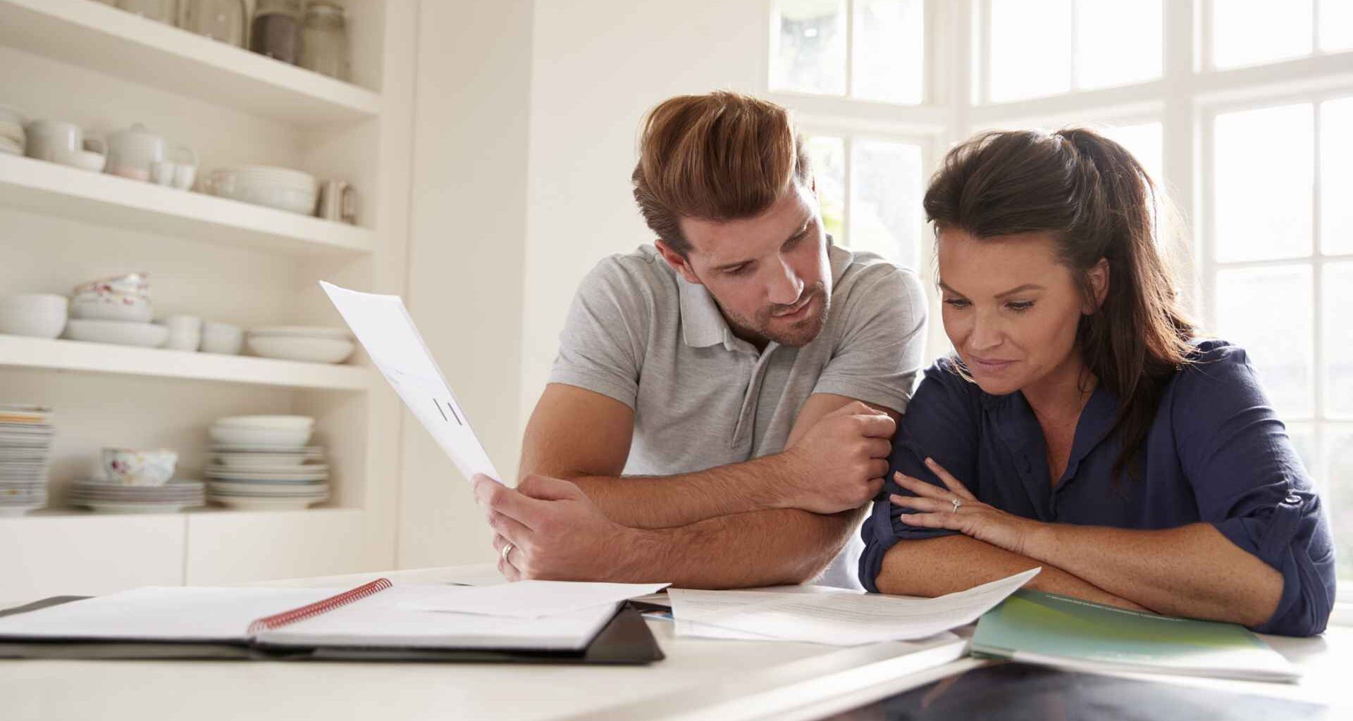 A couple looks at paperwork together.
