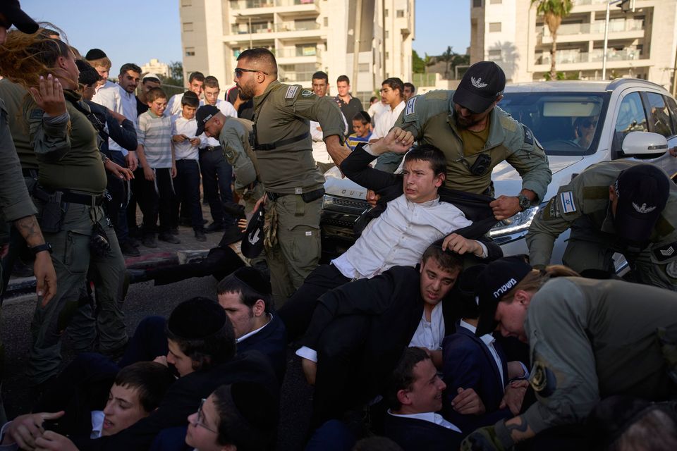 Police disperse ultra-Orthodox Jews blocking a highway during a protest against army recruitment, in Bnei Brak, Israel, Tuesday, Aug. 19, 2025. (AP Photo/Ohad Zwigenberg)