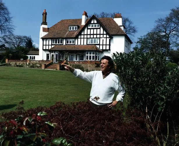 Terry Wogan stood in front of his home