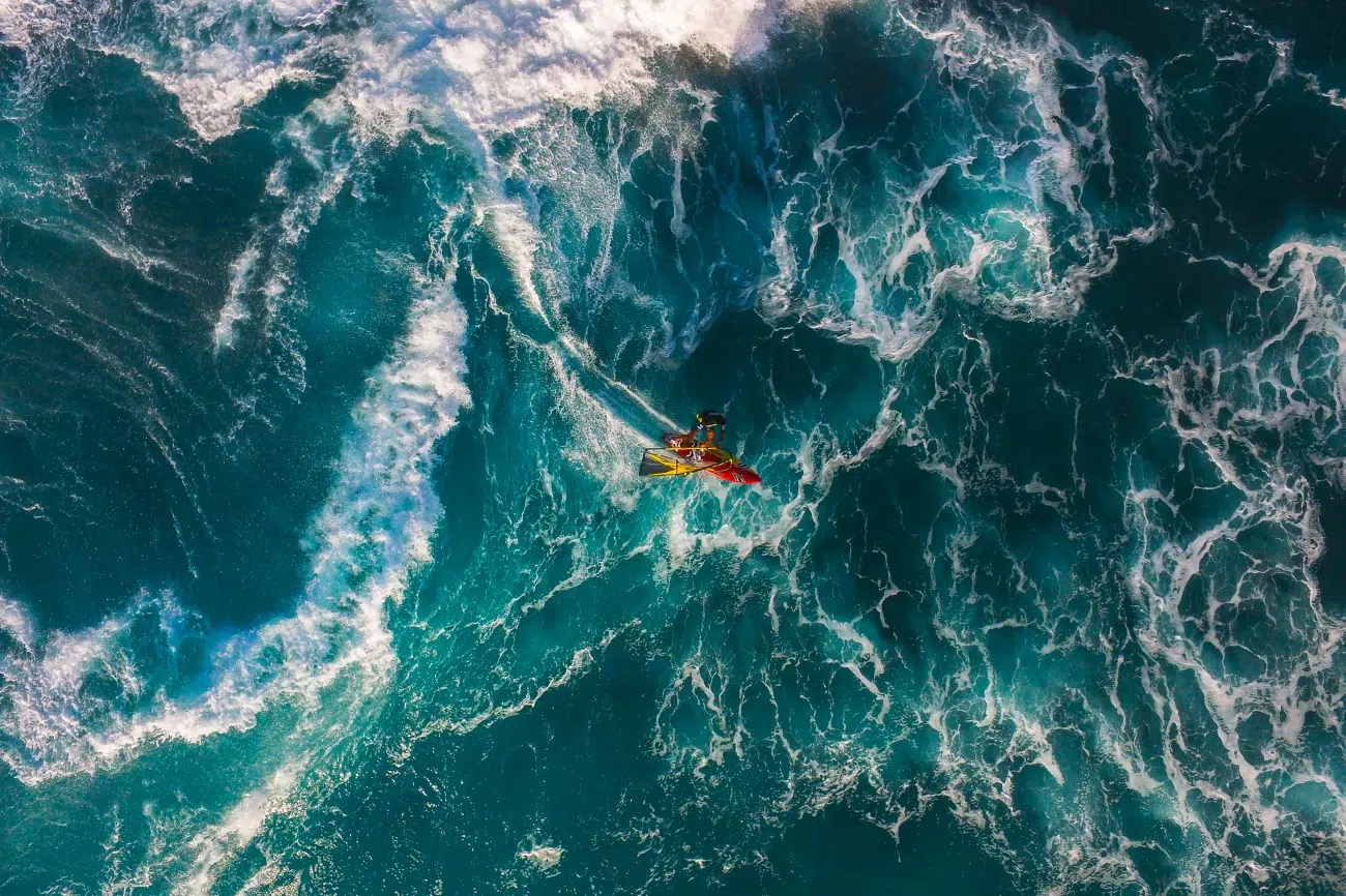Aerial view of a windsurfer riding a wave at Ho’okipa Beach in Maui