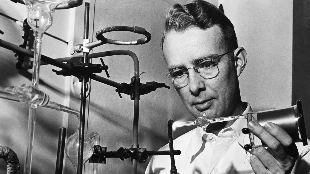 Physicist Luis Alvarez is seen is his laboratory preparing to evacuate a Geiger counter which is used to measure radioactivity.