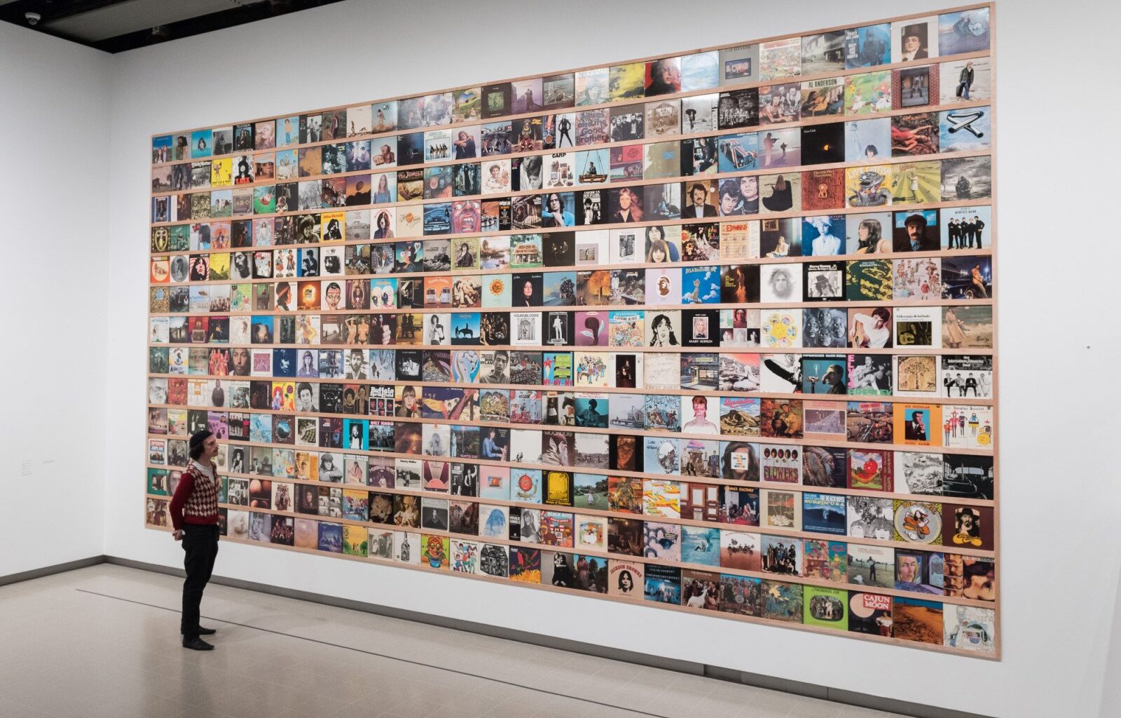 LONDON, UNITED KINGDOM - JUNE 09, 2025: A staff member looks at a selection of record sleeves from Yoshitomo Nara