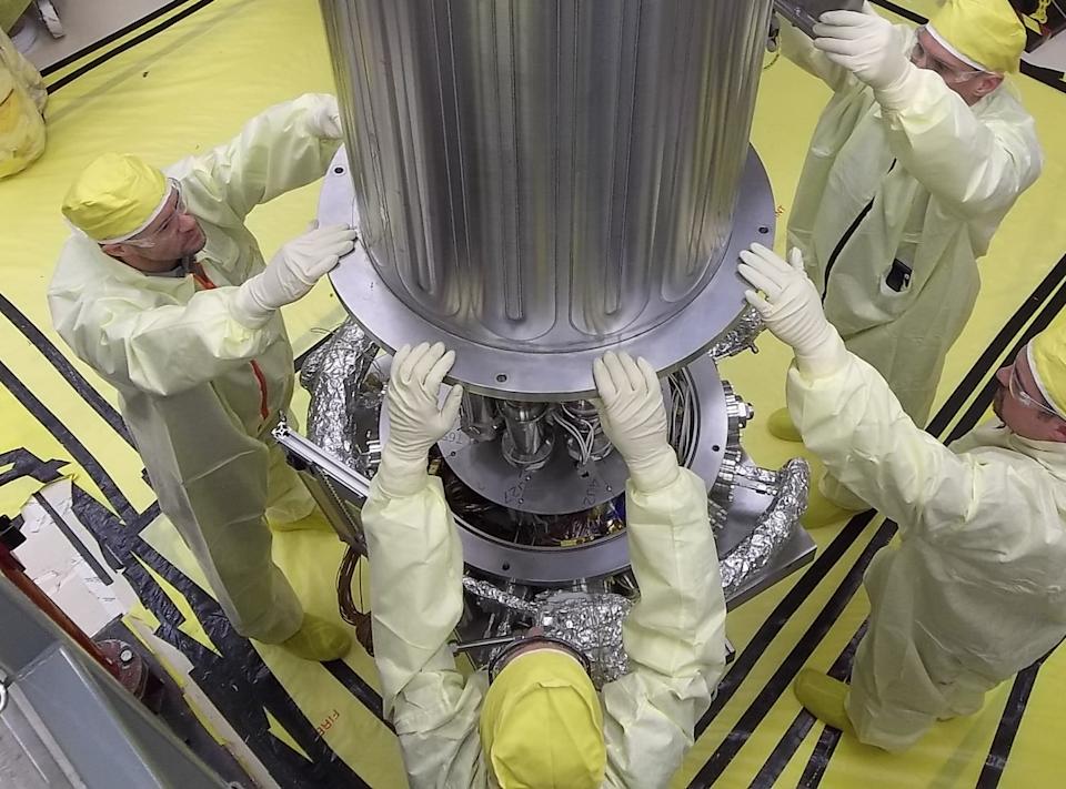 NASA and NNSA engineers lower the wall of the vacuum chamber around KRUSTY system.