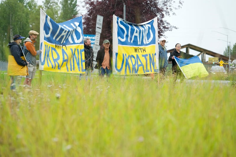 Protesters hold up Ukrainian flags outside Joint Base Elmendorf-Richardson during a meeting between US President Donald Trump and Russian President Vladimir Putin in Anchorage, Alaska. Photograph: Bastien Inzaurralde/AFP via Getty Images