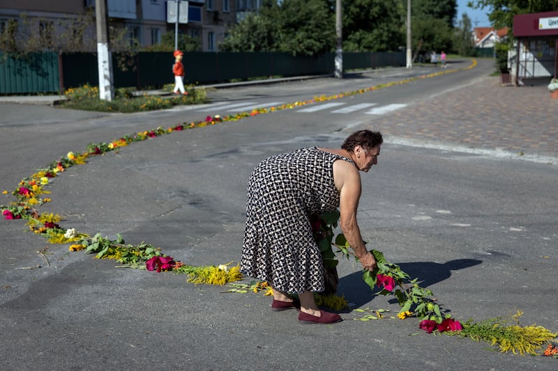 A woman lays flowers in preparation for the funeral of a Ukrainian soldier killed in the Donetsk region of eastern Ukraine. Photograph: Finbarr O'Reilly/New York Times 