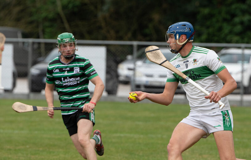 Kanturk's Colin Walsh about to clear the ball away from Kevin McSweeney of Douglas. Picture: Howard Crowdy
