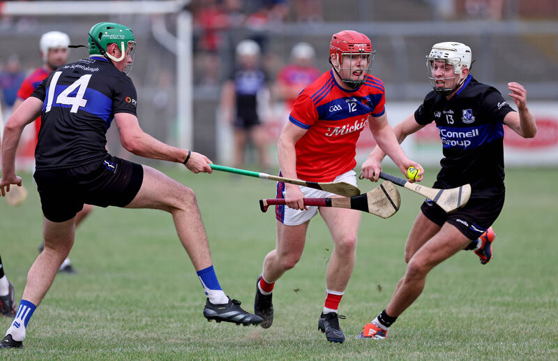 James Sweeney and Ben Nodwell, Sarsfields battle Peter O'Shea, Erins Own. Picture: Jim Coughlan.  James Sweeney and Ben Nodwell, Sarsfields battle Peter O'Shea, Erins Own. Picture: Jim Coughlan.