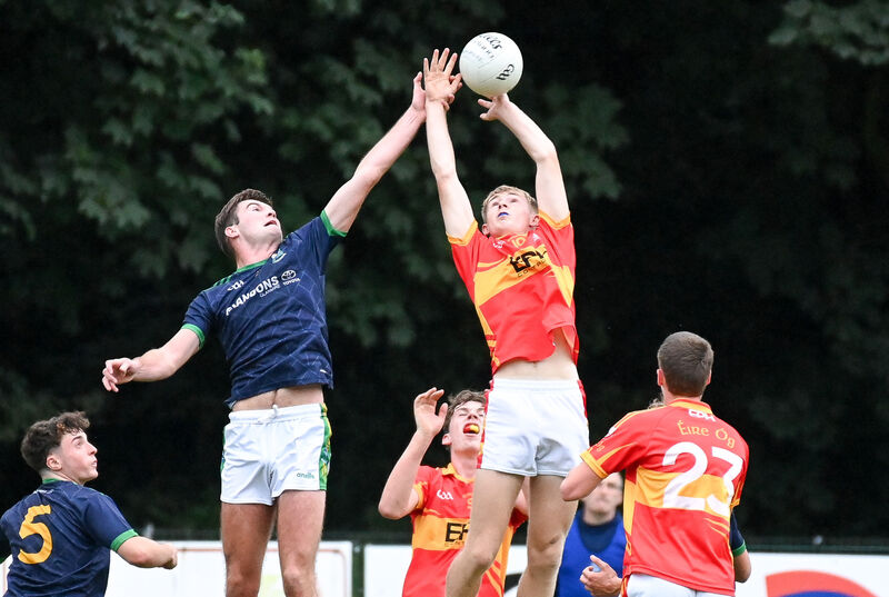  Glanmire's Rory Higgins and Éire Óg's Ethan Hyde compete in the air. Picture: David Keane.