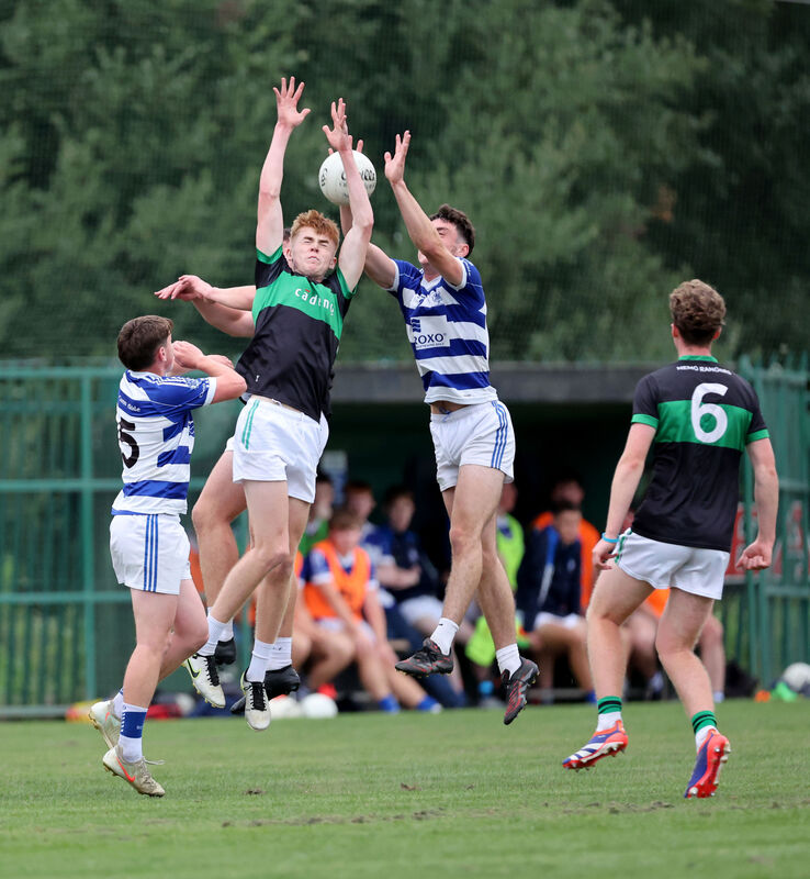  Matthew Keenan and Larry Butler, Nemo Rangers, battle for the high ball with Ben Long, Kinsale. 
