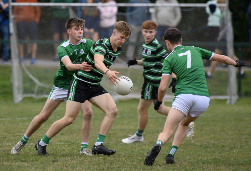  Liam Kelleher, Douglas, looking to break between Ballincollig players Darragh Crowley and Alex Rose. Picture: Dan Linehan