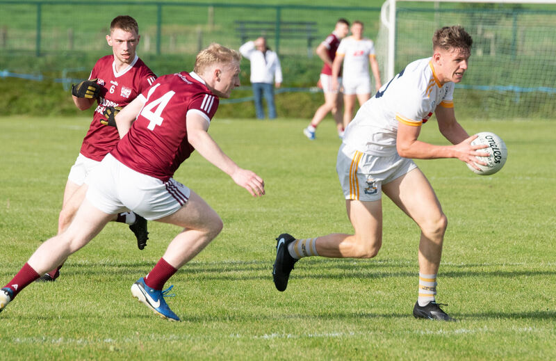 Bandon's Jack Cullinane pulls away from Rockchapel's Jack Curtin. Picture: Howard Crowdy
