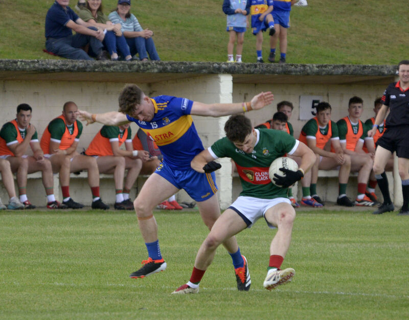 Clonakilty's Dan Darragh being tackled by Carrigaline's Éanna Desmond. Picture: Denis Boyle