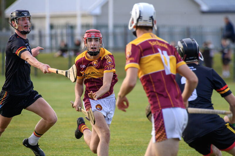 Jamie Lenane, Youghal, gets his pass away under pressure from Darragh Cahill, St Colman's. Picture Dan Linehan  Jamie Lenane, Youghal, gets his pass away under pressure from Darragh Cahill, St Colman's. Picture Dan Linehan