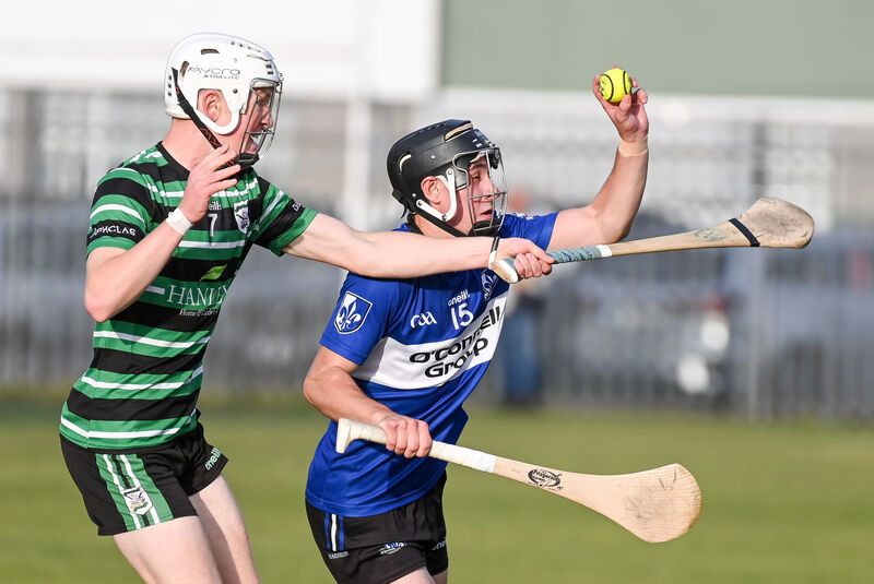 Sarsfields' Adam Leahy wins possession ahead of Douglas' James Gordon. Picture: David Keane.  Sarsfields' Adam Leahy wins possession ahead of Douglas' James Gordon. Picture: David Keane.