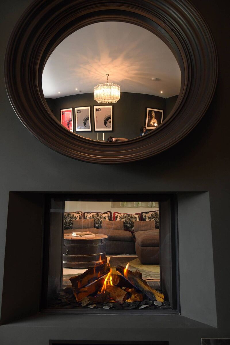 A double-sided stove provides a view into the open-plan area from the cosy sitting room. A double-sided stove provides a view into the open-plan area from the cosy sitting room.
