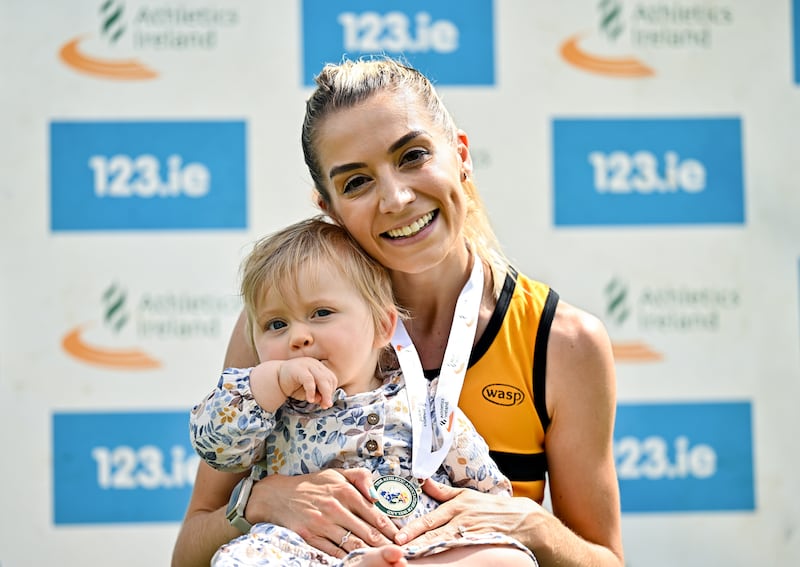 Niamh Allen celebrates with her daughter Lily after winning the 5,000m race at the National Track and Field Senior Championships at Morton Stadium, Dublin. Photograph: Sam Barnes/Sportsfile