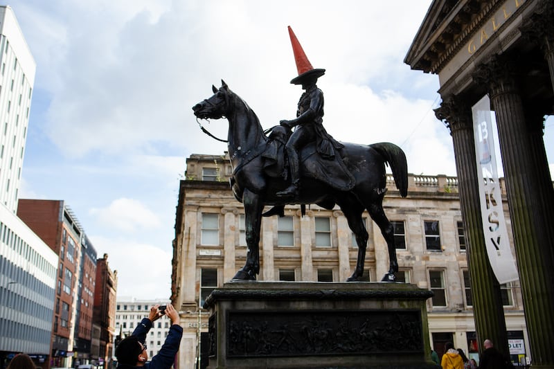 The Duke of Wellington statue crowned with a traffic cone outside the Gallery of Modern Art in Glasgow.  Photograph: Emily Macinnes/Bloomberg via Getty Images