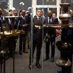 A man staring into a vitrine with ceremonial objects.