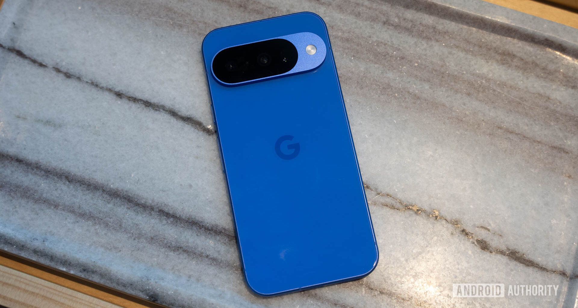 Google Pixel 10 in Indigo flat on marble table