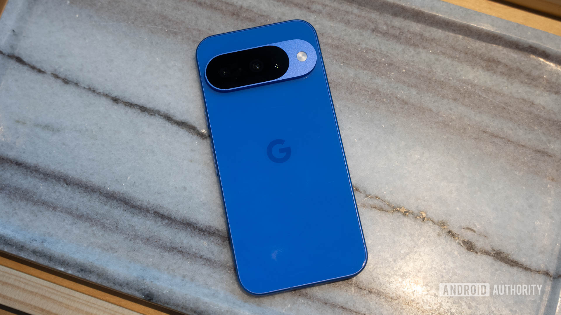 Google Pixel 10 in Indigo flat on marble table